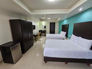 Postel nebo postele na pokoji v ubytování Hotel Maria Elena