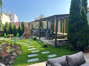 a backyard with a garden with a playground at LEO Apartment FREE PARKING - President Palace in Bratislava