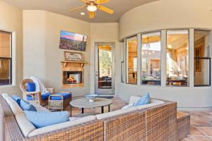 a living room with a couch and a fireplace at The Debonair Derby by PaseoHomesAZ with Heated Pool in Scottsdale