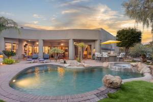 a house with a swimming pool in the yard at The Debonair Derby by PaseoHomesAZ with Heated Pool in Scottsdale