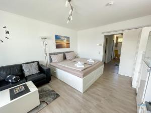 a living room with a bed and a couch at Haus Nautic Döse Wohnung 301 in Cuxhaven +17 photos