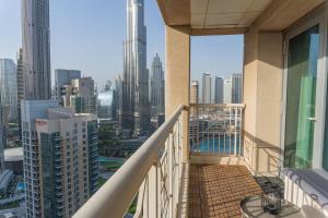 a balcony with a view of a city at Downtown Oasis, Burj Khalifa Views, Luxury Amenities in Dubai