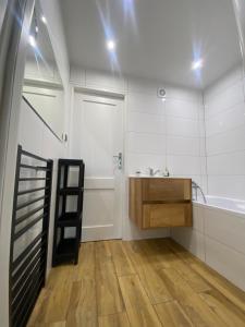 a bathroom with a sink and a mirror at Może nad morze in Gdańsk