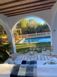 a bedroom with a bed and a view of a pool at Villa Allyson Boutique Guesthouse in Lloret de Mar
