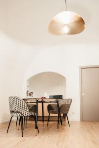 a dining room with a table and chairs at Aparthotel Camere del Capitolo in Bisceglie