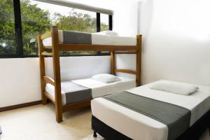 Postel nebo postele na pokoji v ubytování Hotel Palo Alto Laureles