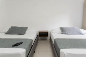 Postel nebo postele na pokoji v ubytování Hotel Palo Alto Laureles
