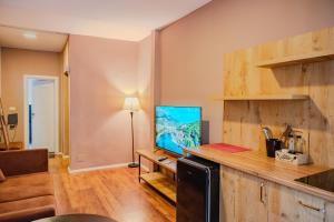 a living room with a television on a counter at BejartApartment2 in Tirana