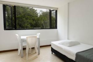 Postel nebo postele na pokoji v ubytování Hotel Palo Alto Laureles