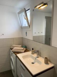 a bathroom with a sink and a washing machine at Beach Front House 'Casa Neen' in Corralejo +32 photos