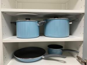 two pots and pans on a shelf in a kitchen at Studio number 15 in Pantin