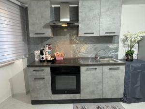 a kitchen with a sink and a stove at Da Riccardo in Fornelli