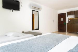 Postel nebo postele na pokoji v ubytování Hotel Palo Alto Laureles