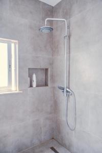 a shower with a glass door in a bathroom at Bejart Apartment 3 in Tirana +40 photos