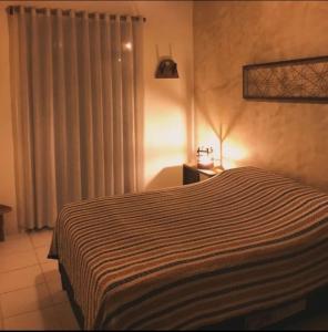 Cama ou camas em um quarto em Casa de Hospedagem "Praia e Coqueiros"