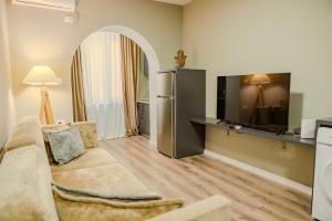 a living room with a couch and a tv at Bejart Apartment 4 in Tirana