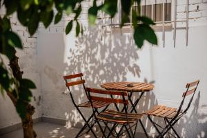 two chairs and a table on a patio at Bejart Apartment 5 in Tirana