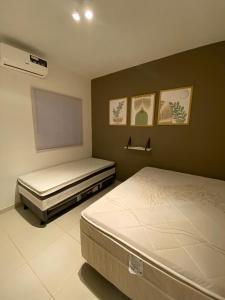 a bedroom with two beds and a flat screen tv at Casa Com Piscina em Jacumã e Carapibus in Jacumã +12 photos