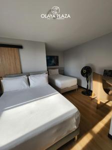 Postel nebo postele na pokoji v ubytování Hotel Olaya Plaza