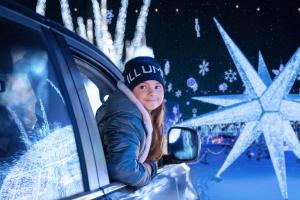 a young girl is leaning out of a car window at Holiday Inn Laval Montreal by IHG in Laval