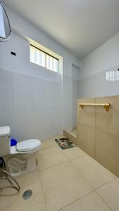 a bathroom with a toilet and a shower at Family Surf Chicama in Puerto Chicama +63 photos
