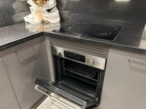 an oven in a kitchen with a counter top at Pinnacle Row Luxe Retreat in Muscat