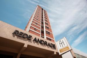 a building with a sign on top of a store at Rede Andrade Goiania Centro in Goiânia