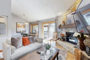 a living room with a couch and a fireplace at Lakeview Townhome Unit A5 in Avon
