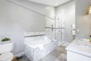 a white bathroom with a tub and a toilet at Lakeview Townhome Unit A5 in Avon +43 photos
