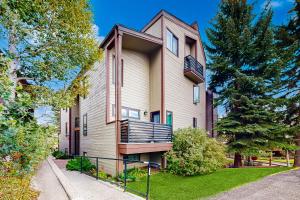 a house with a balcony on the side of it at Lakeview Townhome Unit A5 in Avon