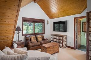 a living room with a couch and a chair at Camp Telluride - golf course, views, hot tub, gym! in Telluride
