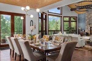 a dining room with a table and chairs at Camp Telluride - golf course, views, hot tub, gym! in Telluride