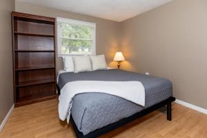 a bedroom with a large bed with a window at Cottage Near Cedar Point & Beach in Huron