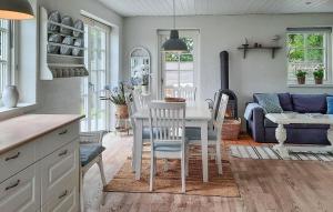 a kitchen and living room with a table and chairs at Amazing Home In Skagen With Wifi in Skagen