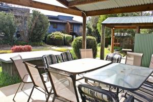 a patio with a table and chairs under a pergola at Cedar Holiday Units - Apartment 2 in Bright