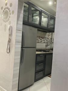 a kitchen with a stainless steel refrigerator and cabinets at طريق الخير 13 in Agadir