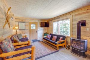 a log cabin living room with a wood stove at Contact Mountain Hideaway with Views and Porches! in McLeod