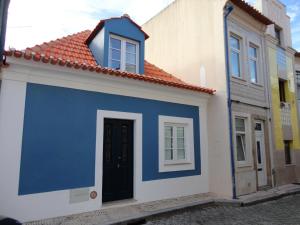 a blue and white building with a red roof at Casa Aveiro Canal da Ria in Aveiro