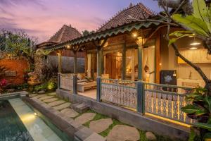 a house with a pool in front of it at Astala Ubud Villa in Ubud