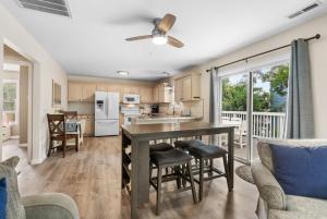 a kitchen and living room with a table and chairs at Beach House with Pool - North Myrtle Beach in Myrtle Beach