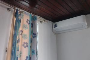 a bathroom with a shower curtain and a window at Hostel Residence Girassol in Belém