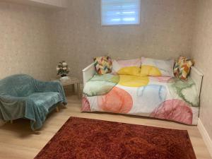 a bedroom with a bed and a chair and a window at Millpond Basement Units in Richmond Hill