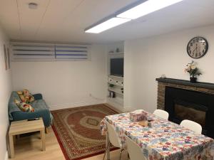 a living room with a table and a fireplace at Millpond Basement Units in Richmond Hill