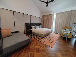 a large bedroom with a bed and a chair at Lone Pine, Penang, a Tribute Portfolio Resort in Batu Ferringhi