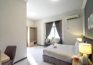 Postel nebo postele na pokoji v ubytování Tanjung Puteri Golf and Resort Malaysia