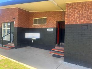 a brick building with a window on the side of it at Gunnedah Tourist Caravan Park in Gunnedah