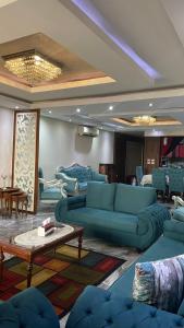 a living room with blue couches and a table at شقة مفروشه على النيل in Cairo
