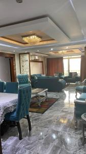 a living room with couches and a table and chairs at شقة مفروشه على النيل in Cairo