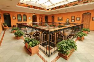 a large room with a large staircase leading to a building at Hotel Alabardero in Seville