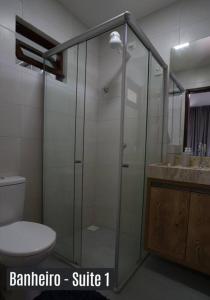 a bathroom with a shower and a toilet and a sink at Chalé Exclusivo Condomínio Águas da Serra in Bananeiras